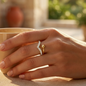 A gold ring with a wavy design studded with feldspar, featuring an elegant spherical touch