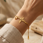 Gold-plated stainless steel bracelet with a heartbeat and heart pendant design