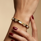 Stainless steel bracelet with studded floral accents and mother-of-pearl.
