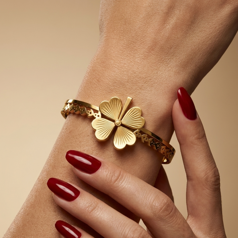 Stainless steel bracelet with an ornate clover petal design.