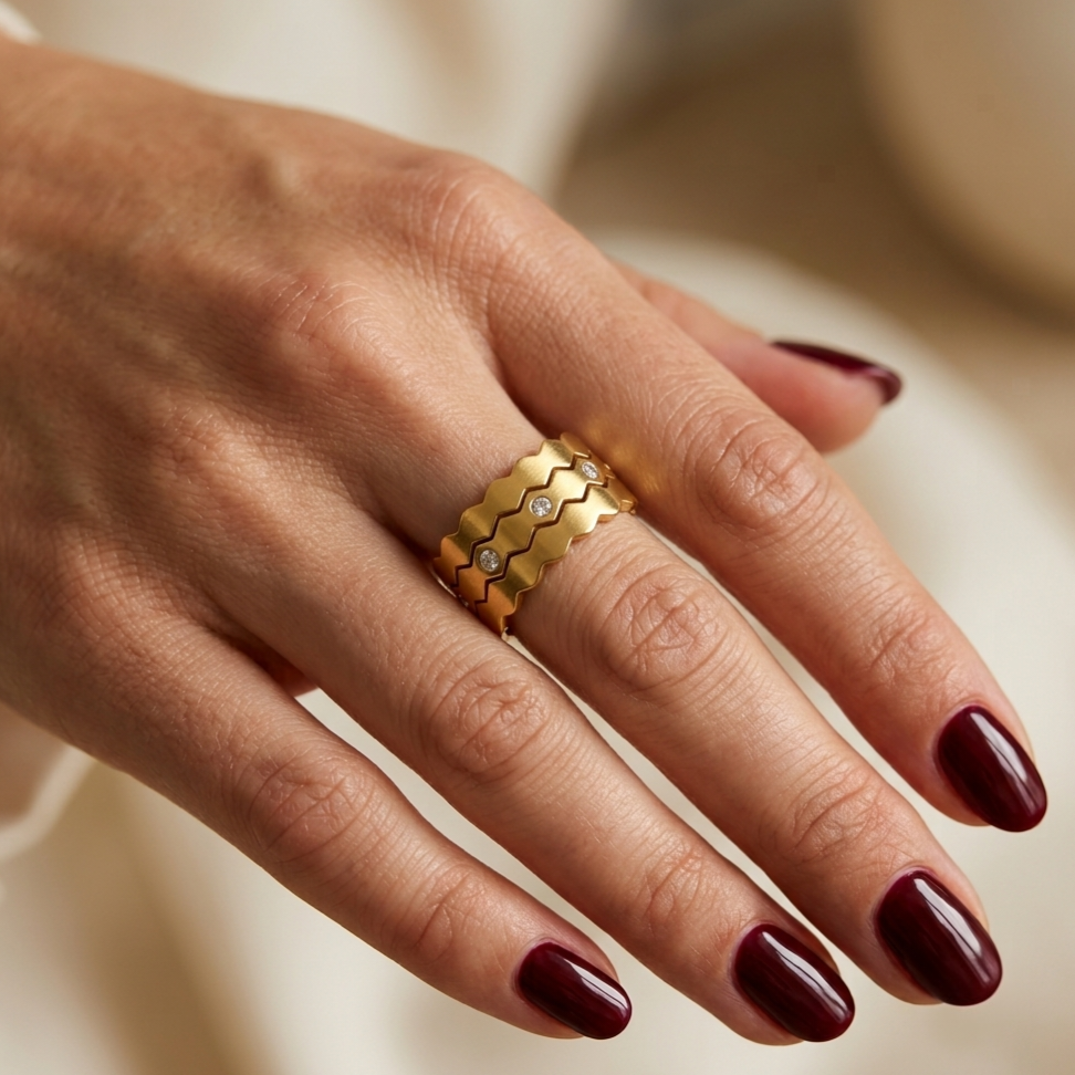Open stainless steel ring with wavy layered design and zircon.