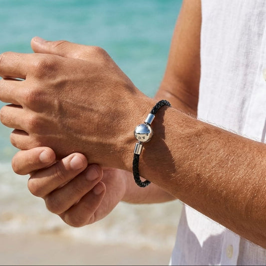 Men's black braided leather bracelet with a silver ball clasp