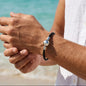 Men's black braided leather bracelet with a silver ball clasp