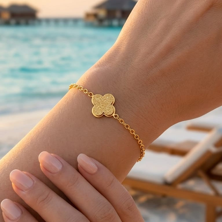 A delicate bracelet with a sandy clover charm
