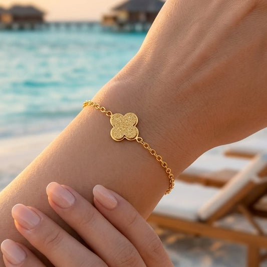 A delicate bracelet with a sandy clover charm