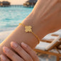 A delicate bracelet with a sandy clover charm