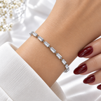 Silver stainless steel tennis bracelet featuring trapezoid-cut zirconia stones.