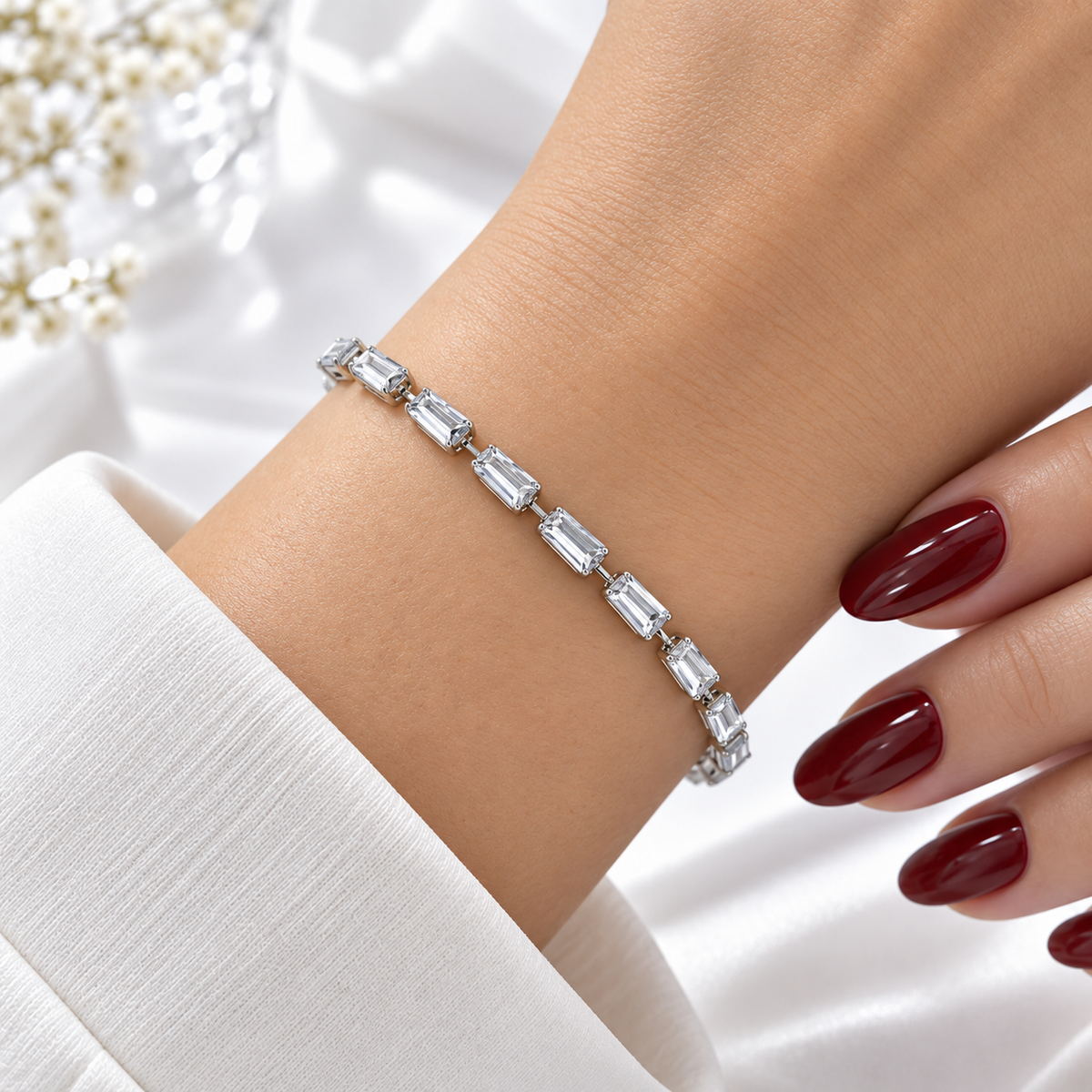 Silver stainless steel tennis bracelet featuring trapezoid-cut zirconia stones.