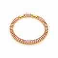 Gold-tone stainless steel tennis bracelet set with pink zircon stones.
