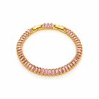 Gold-tone stainless steel tennis bracelet set with pink zircon stones.