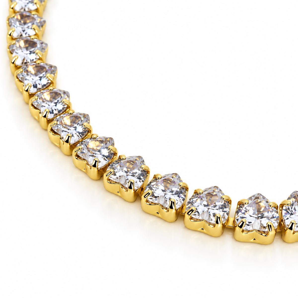 Gold-tone stainless steel tennis bracelet featuring heart-shaped zirconia stones.