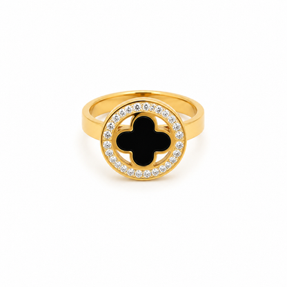 A round gold ring encrusted with turquoise with a black clover flower