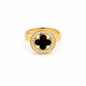 A round gold ring encrusted with turquoise with a black clover flower