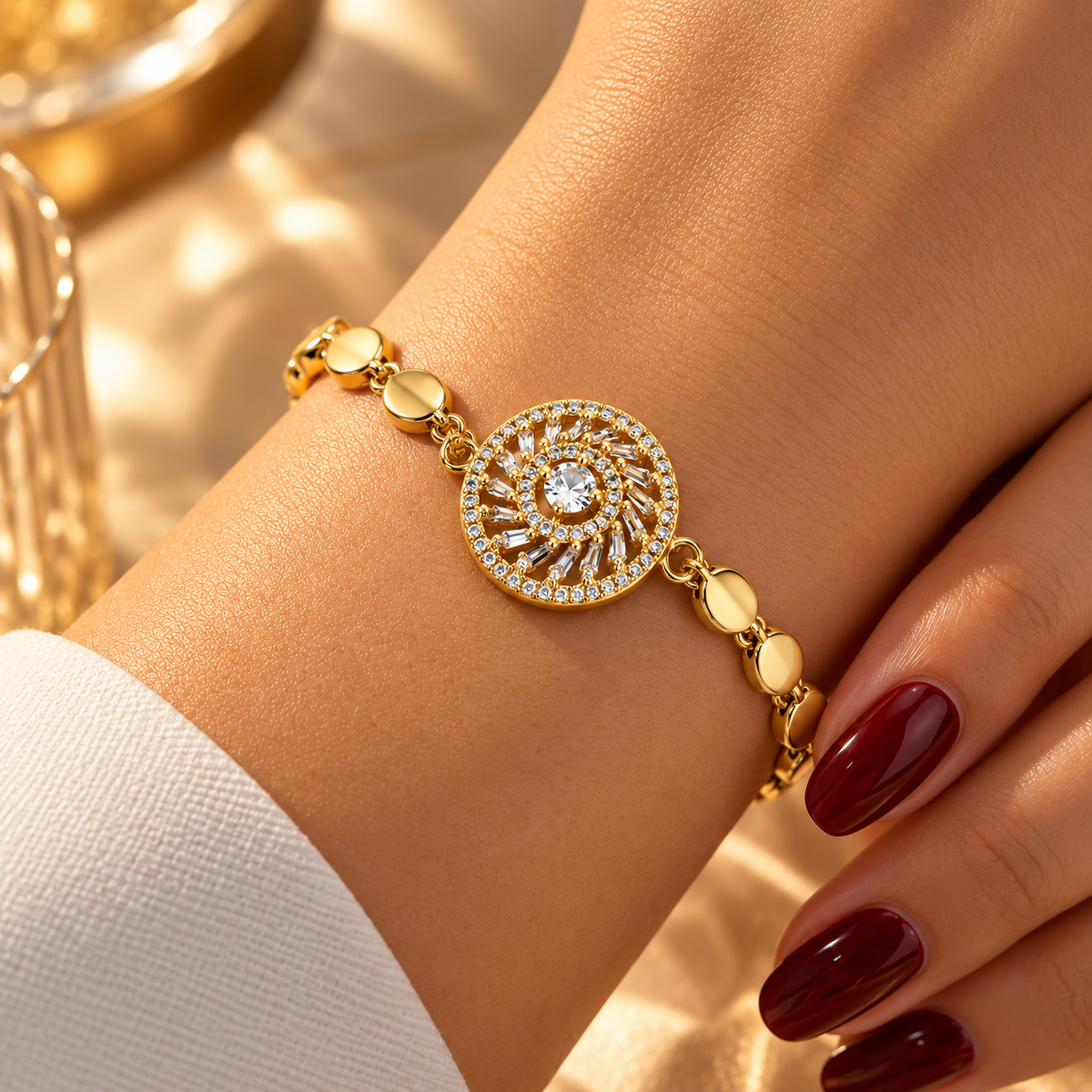 Gold stainless steel bracelet featuring a studded circular charm and a sun-eye motif.
