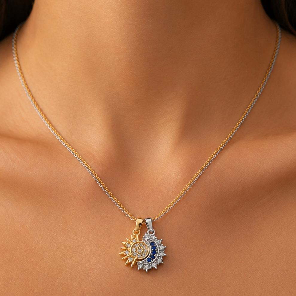 Stainless steel necklace with a double sun and moon design, studded with crystals.