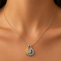 Stainless steel necklace with a double sun and moon design, studded with crystals.