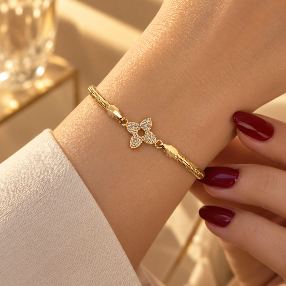 Stainless steel snake chain bracelet with an embellished flower
