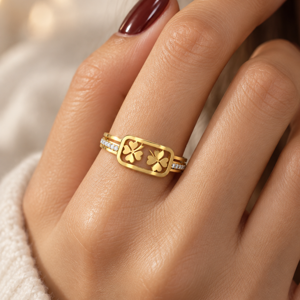 Open stainless steel ring featuring a clover leaf frame and zircon.