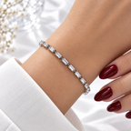 Silver stainless steel tennis bracelet featuring rectangular zirconia stones.