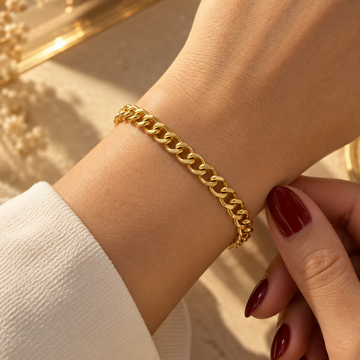 Stainless steel bracelet with a delicate gold chain link design.