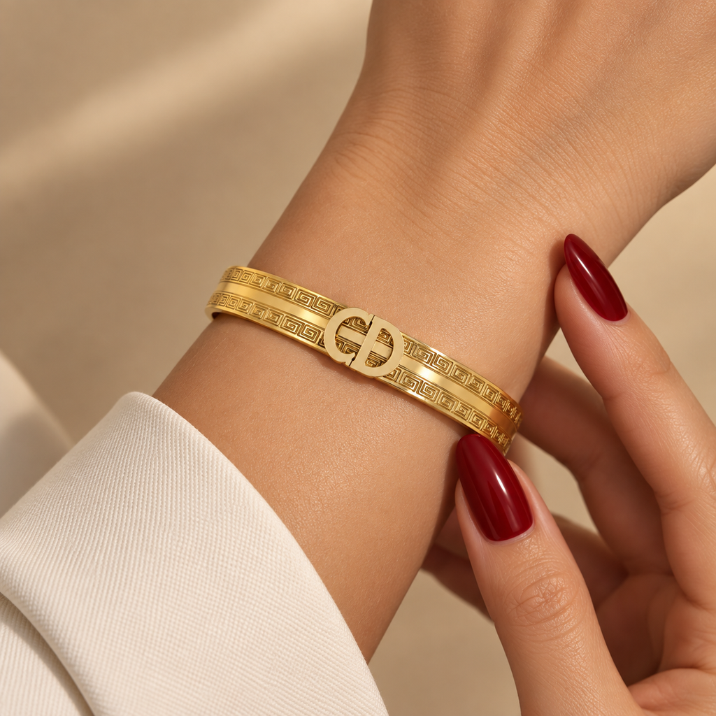 Stainless steel bracelet featuring the "CD" initials and a geometric pattern.