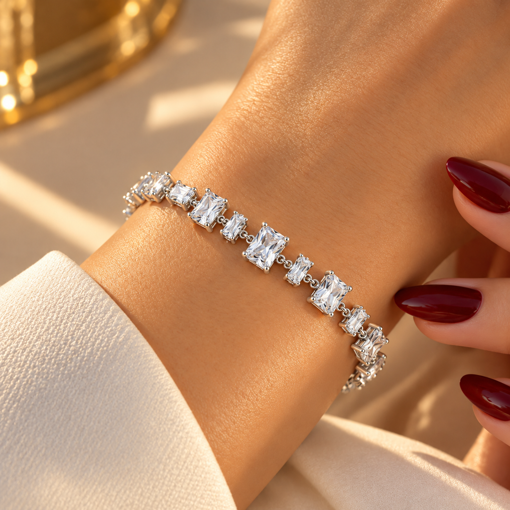 Silver stainless steel tennis bracelet featuring graduated rectangular zirconia stones.