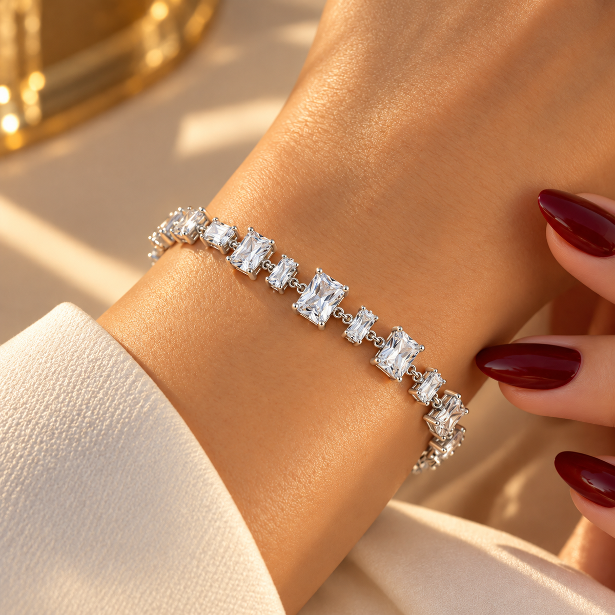 Silver stainless steel tennis bracelet featuring graduated rectangular zirconia stones.