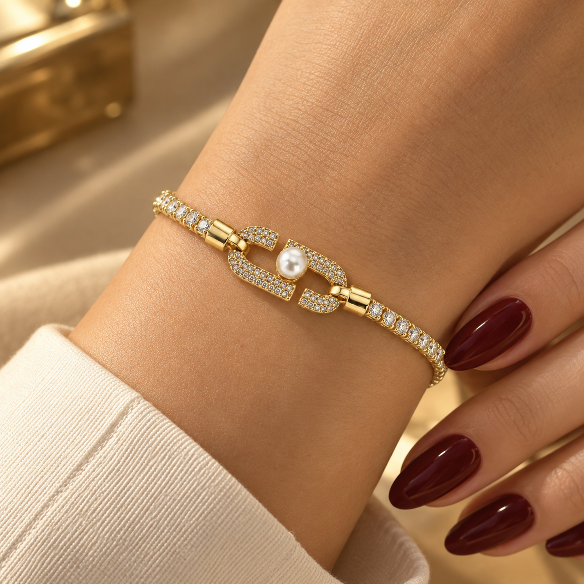 Stainless steel tennis bracelet featuring an embellished link and a pearl.