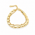 Double-strand stainless steel bracelet featuring geometric links and gold beads.