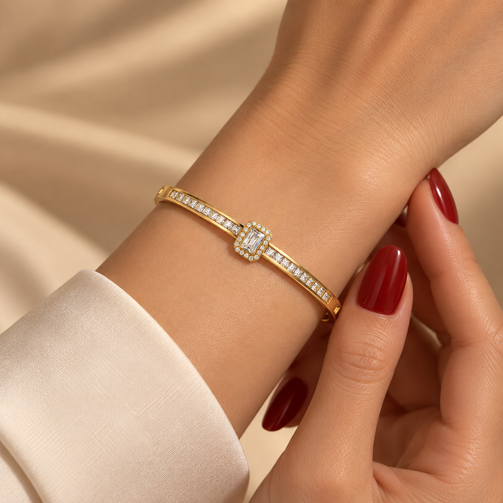 Stainless steel bracelet with a crystal emerald stone and a studded band.
