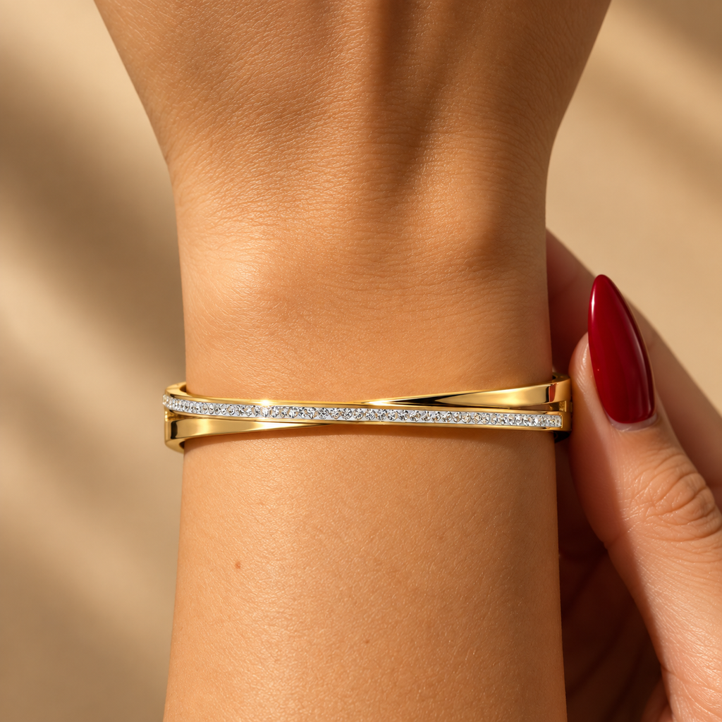Stainless steel bracelet with an interlocking, embellished design.