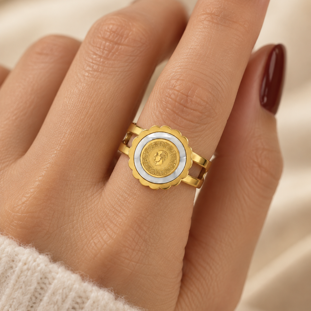 Open stainless steel ring with a gold coin and a shell-style rim.