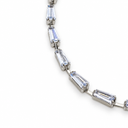 Silver stainless steel tennis bracelet featuring trapezoid-cut zirconia stones.