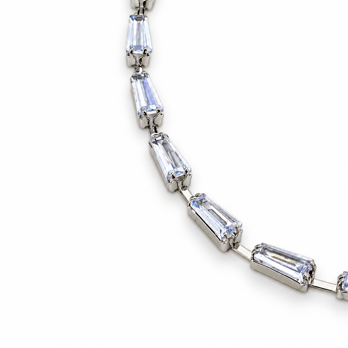 Silver stainless steel tennis bracelet featuring trapezoid-cut zirconia stones.