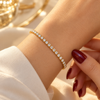 Gold-tone stainless steel tennis bracelet set with zircon stones.