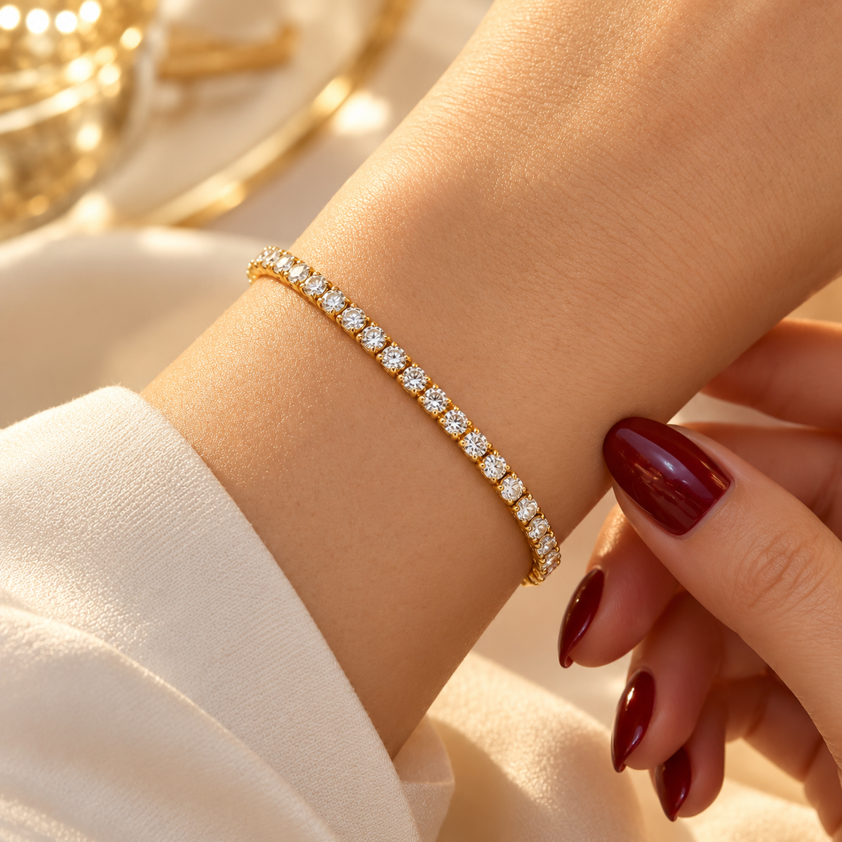 Gold-tone stainless steel tennis bracelet set with zircon stones.