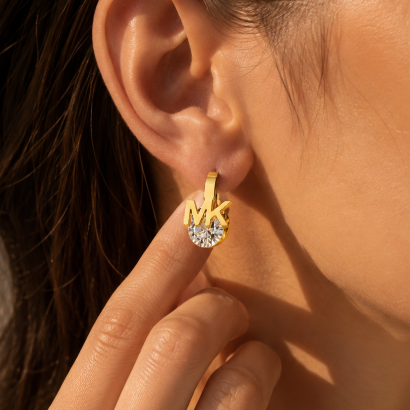 Gold-plated stainless steel earrings with a letter design and sparkling crystals