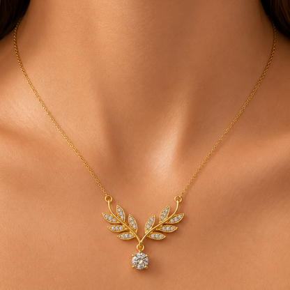 Gold-plated stainless steel necklace with a leaf design and crystal stone