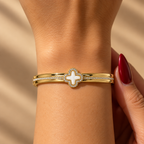 Stainless steel bracelet with an embellished mother-of-pearl flower.