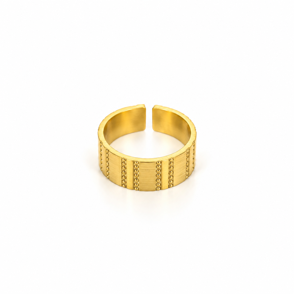 Open stainless steel ring with a wide surface and textured lines.