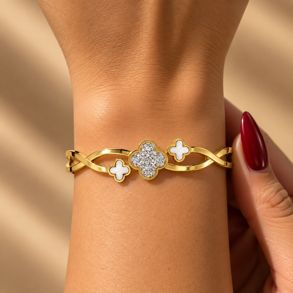 Stainless steel bracelet featuring mother-of-pearl flowers and stone embellishments.