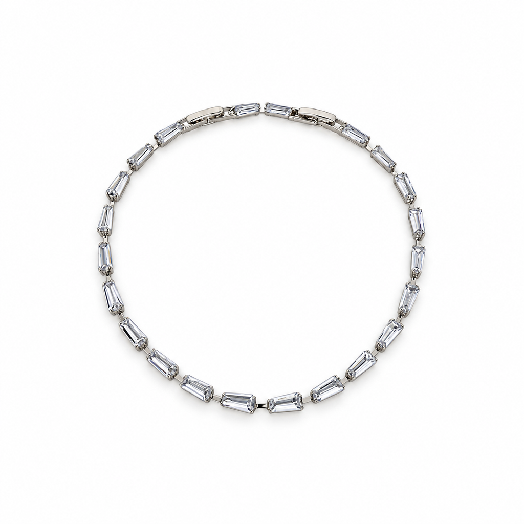 Silver stainless steel tennis bracelet featuring trapezoid-cut zirconia stones.