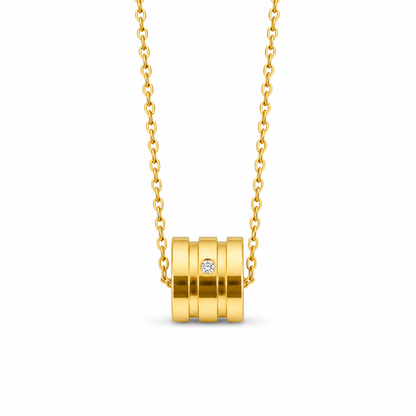 "Golden Cylinder" Necklace – A crystal-encrusted cylindrical pendant in gold-tone stainless steel