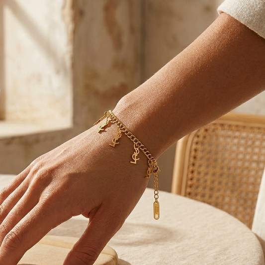 "Logo Charm" gold bracelet - stainless steel with a smooth chain design and dangling letters