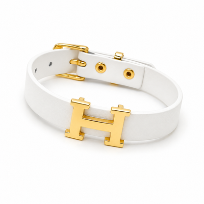 A modern bracelet with a white strap and a gold "H" logo – a touch of classic elegance