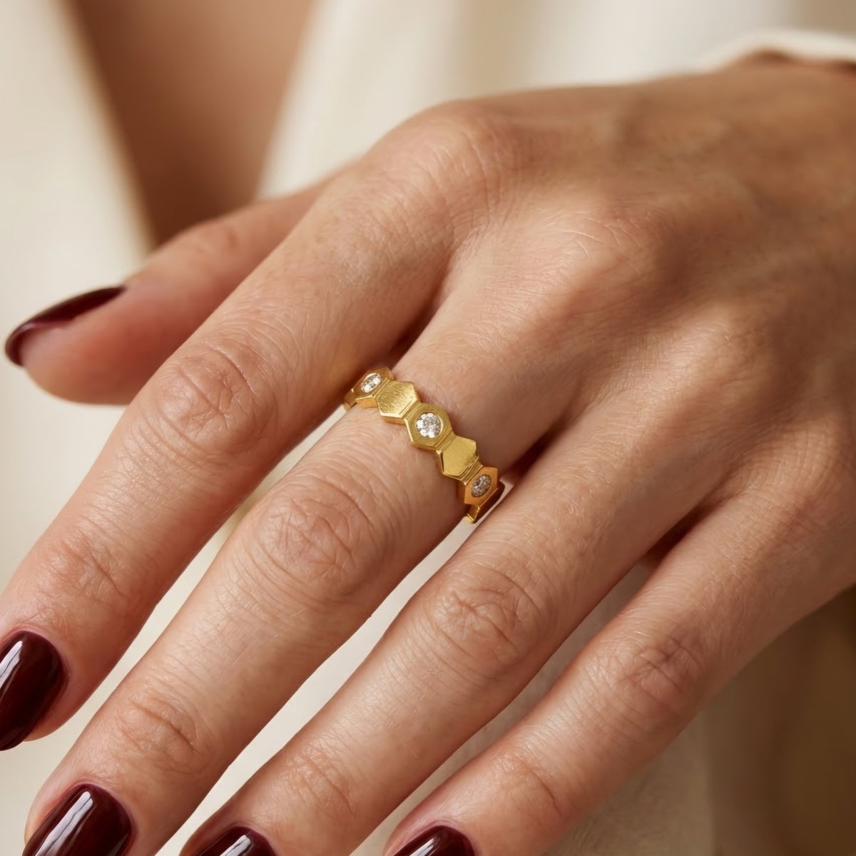 Open stainless steel ring with a honeycomb design and zirconia.