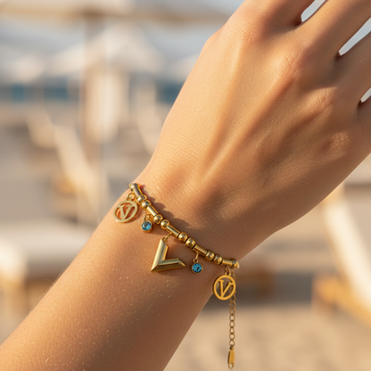 Stainless steel bracelet with gold plating and trendy charms (V letter and blue stones) - elegant design