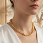 Wide chain necklace with a shiny gold finish - a bold, modern design